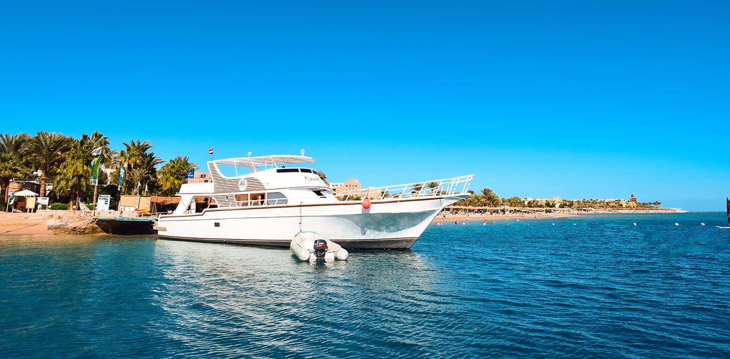 A dive boat moored off the beach in Makadi Bay